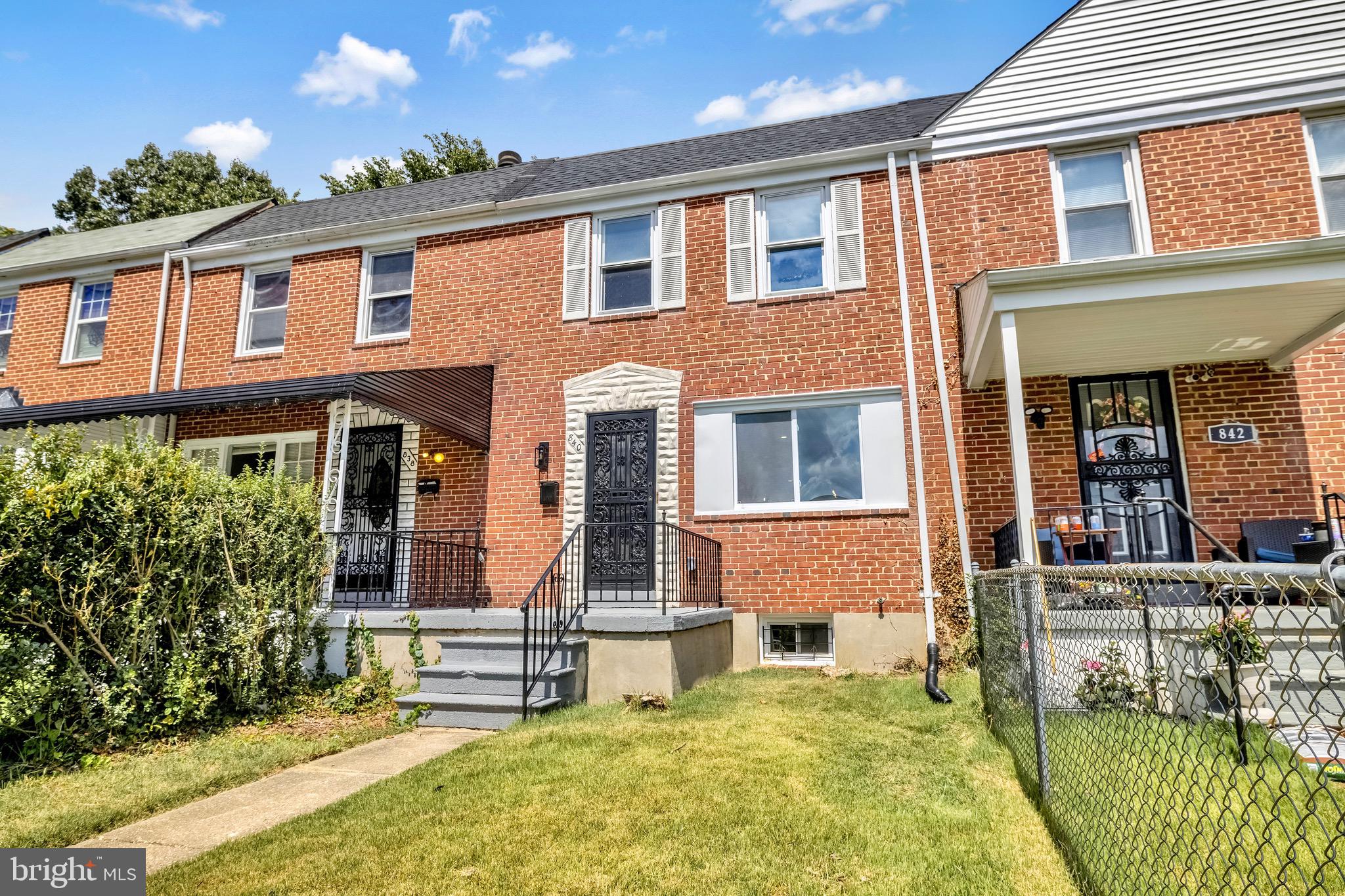 840 Benninghaus Road Baltimore, MD 21212 - Photo 29 of 30 front view of a brick house with a large windows and a yard