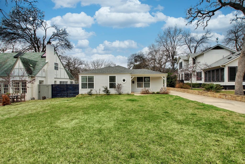 a front view of a house with a garden