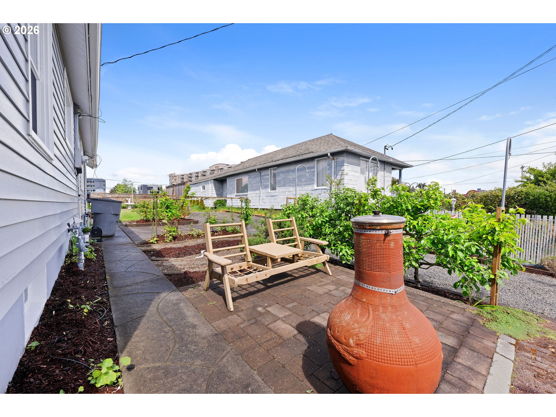 416 South Downing Street Seaside, OR 97138 - Photo 18 of 48 a view of a patio with table and chairs potted plants with wooden fence