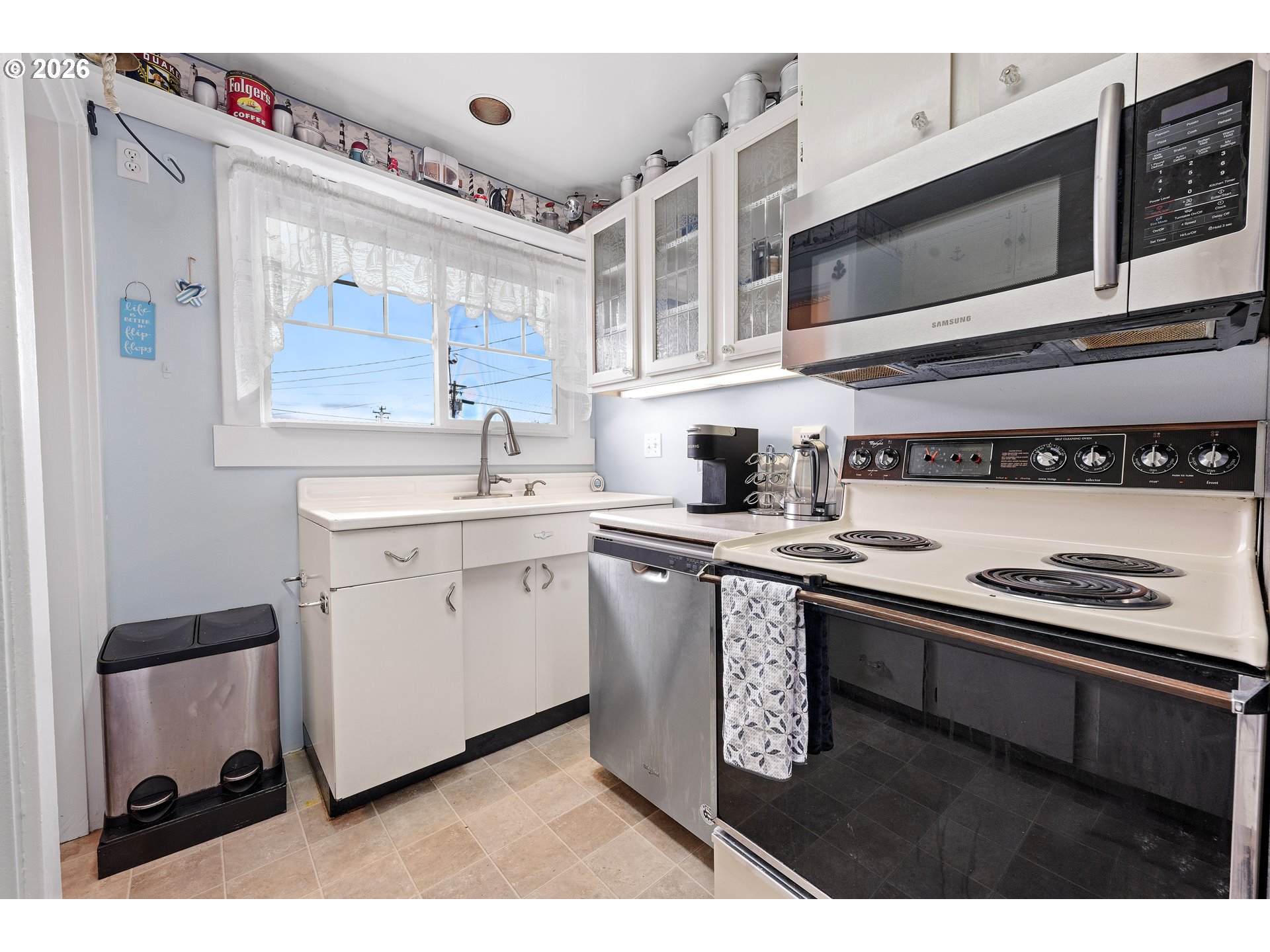 416 South Downing Street Seaside, OR 97138 - Photo 28 of 48 a kitchen with stainless steel appliances a sink stove and cabinets