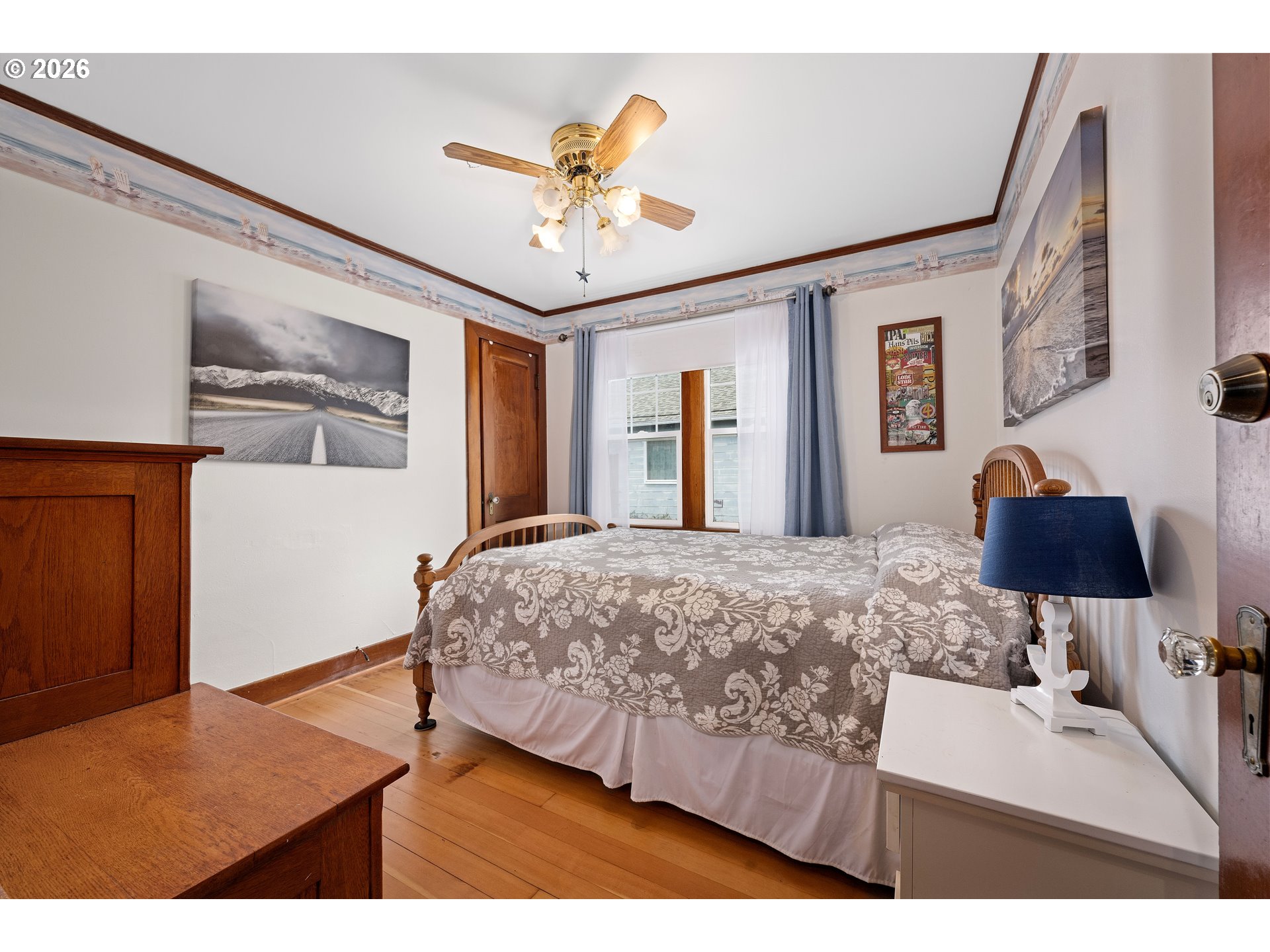 416 South Downing Street Seaside, OR 97138 - Photo 33 of 48 a bedroom with a bed and a chandelier