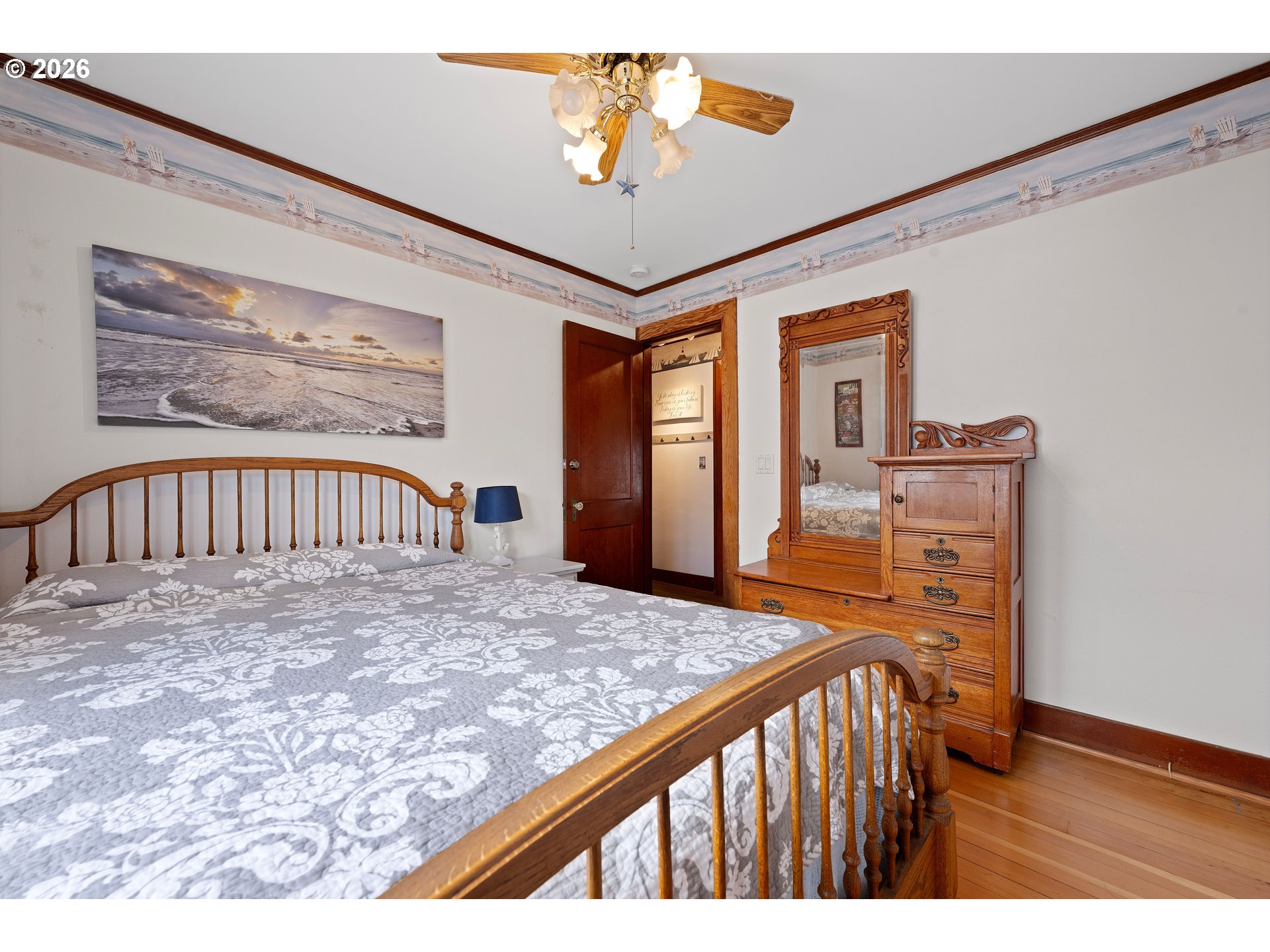 416 South Downing Street Seaside, OR 97138 - Photo 34 of 48 a bedroom with a bed and a chandelier