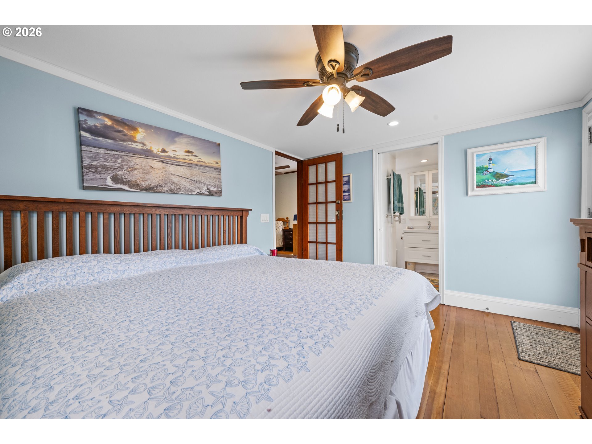 416 South Downing Street Seaside, OR 97138 - Photo 41 of 48 a bedroom with a bed and a chandelier