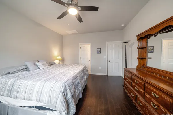 a spacious bedroom with a bed and a chandelier