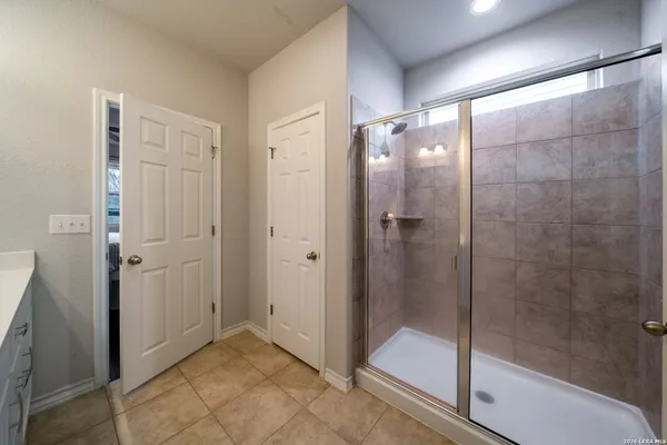 a bathroom with a shower and a sink