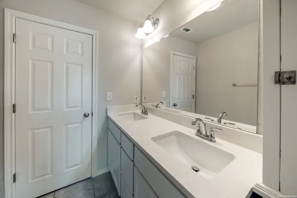 a bathroom with 2 sink and a mirror