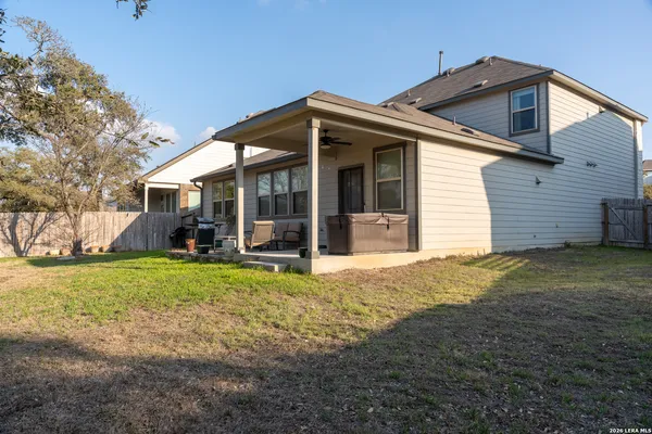 a view of a house with backyard and porch