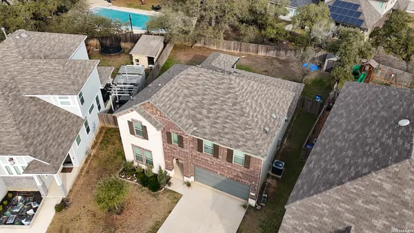 an aerial view of a house with a yard