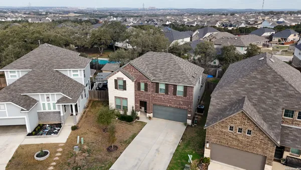 an aerial view of a house with a yard