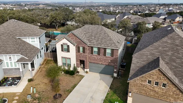 an aerial view of a house with a yard and balcony