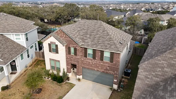 an aerial view of a house with a yard