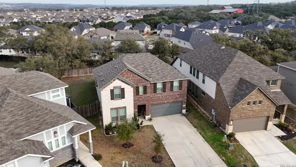 an aerial view of a house with a yard