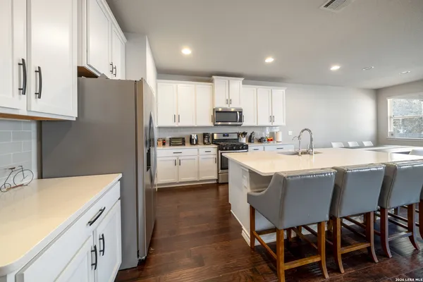 a kitchen with a sink a counter space stainless steel appliances and cabinets