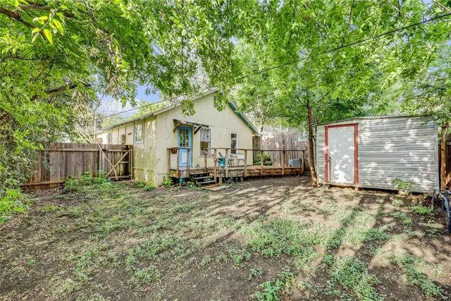 a view of backyard of house with deck and outdoor seating