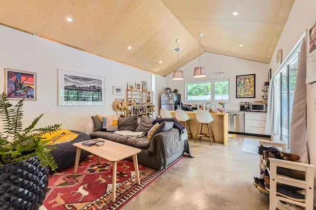 a living room with lots of furniture and a large window