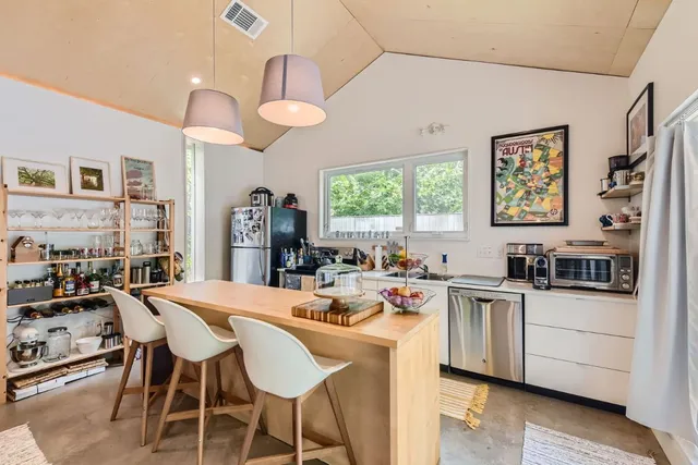 a view of a dining room with furniture and a chandelier