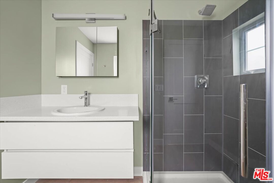 1317 Punta Gorda Street, Unit 11 Santa Barbara, CA 93103 - Photo 19 of 70 a bathroom with a sink and a mirror