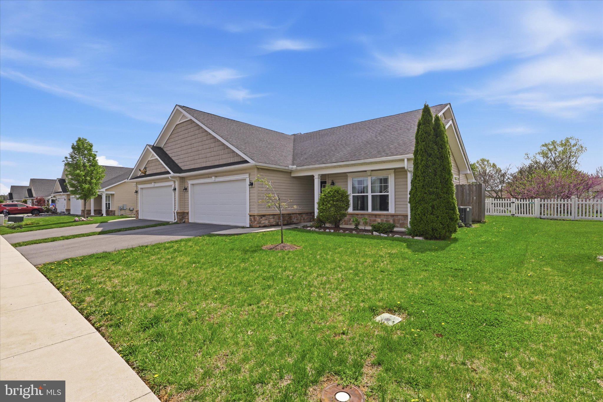 Charming home with lush green lawn.