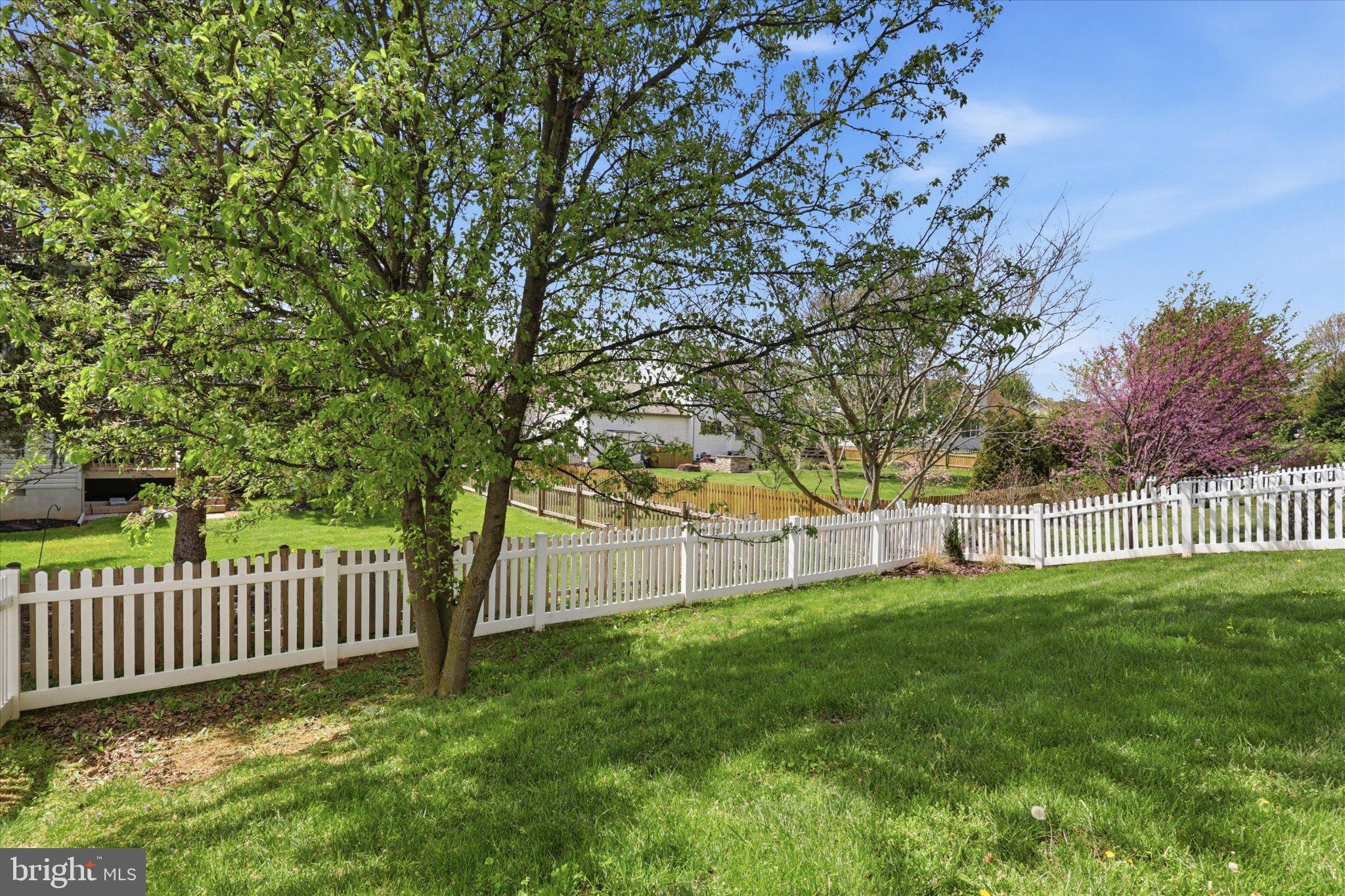 75 Saffron Terrace Falling Waters, WV 25419 - Photo 42 of 46 Lush green yard with white picket fence.