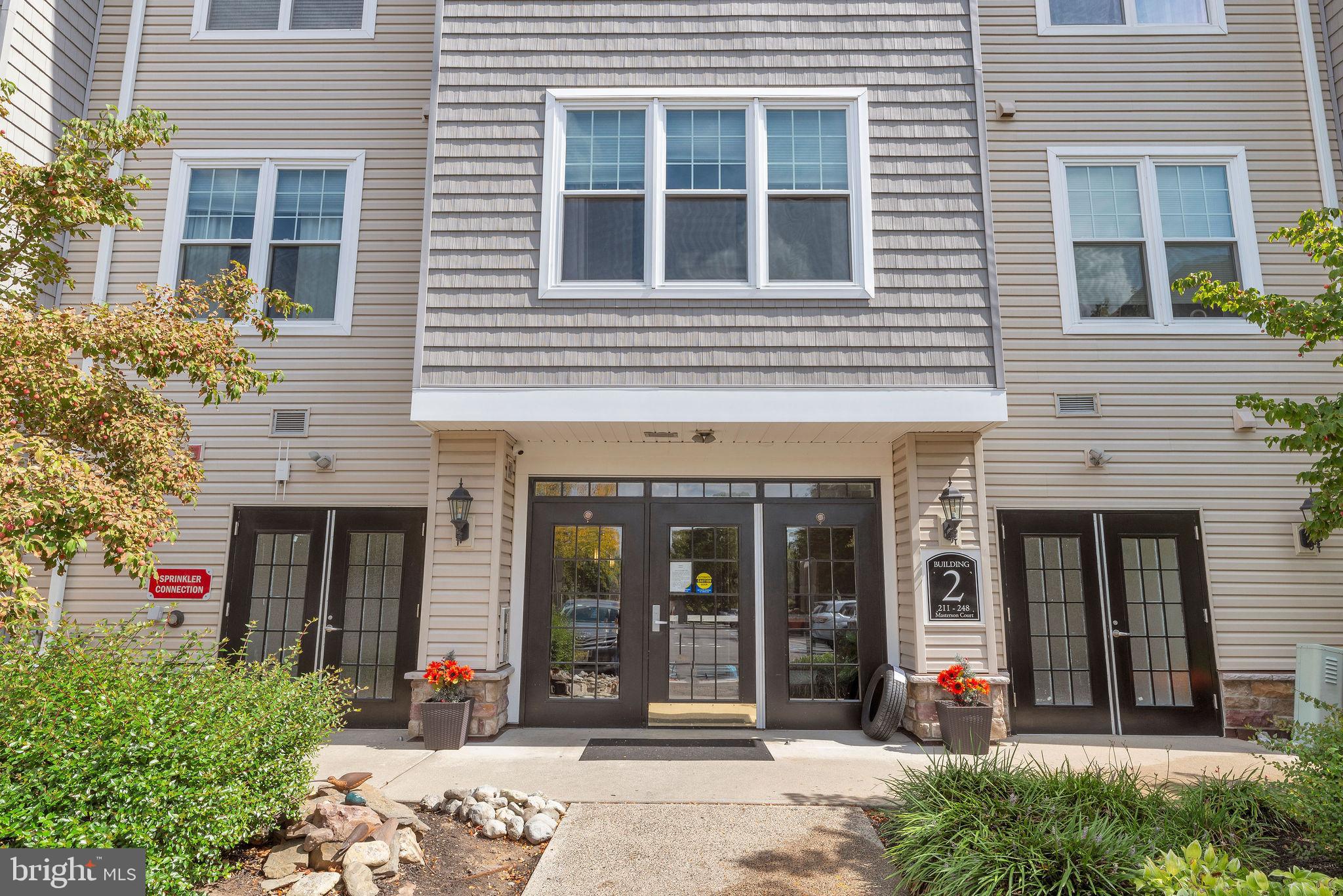 222 Masterson Court Ewing, NJ 08618 - Photo 1 of 43 front view of a brick house with a large window