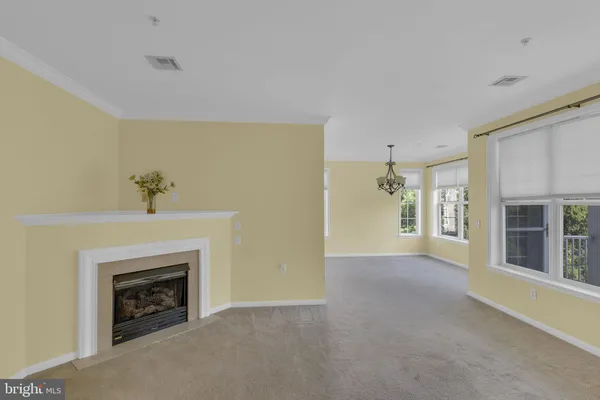 a view of an empty room with a fireplace