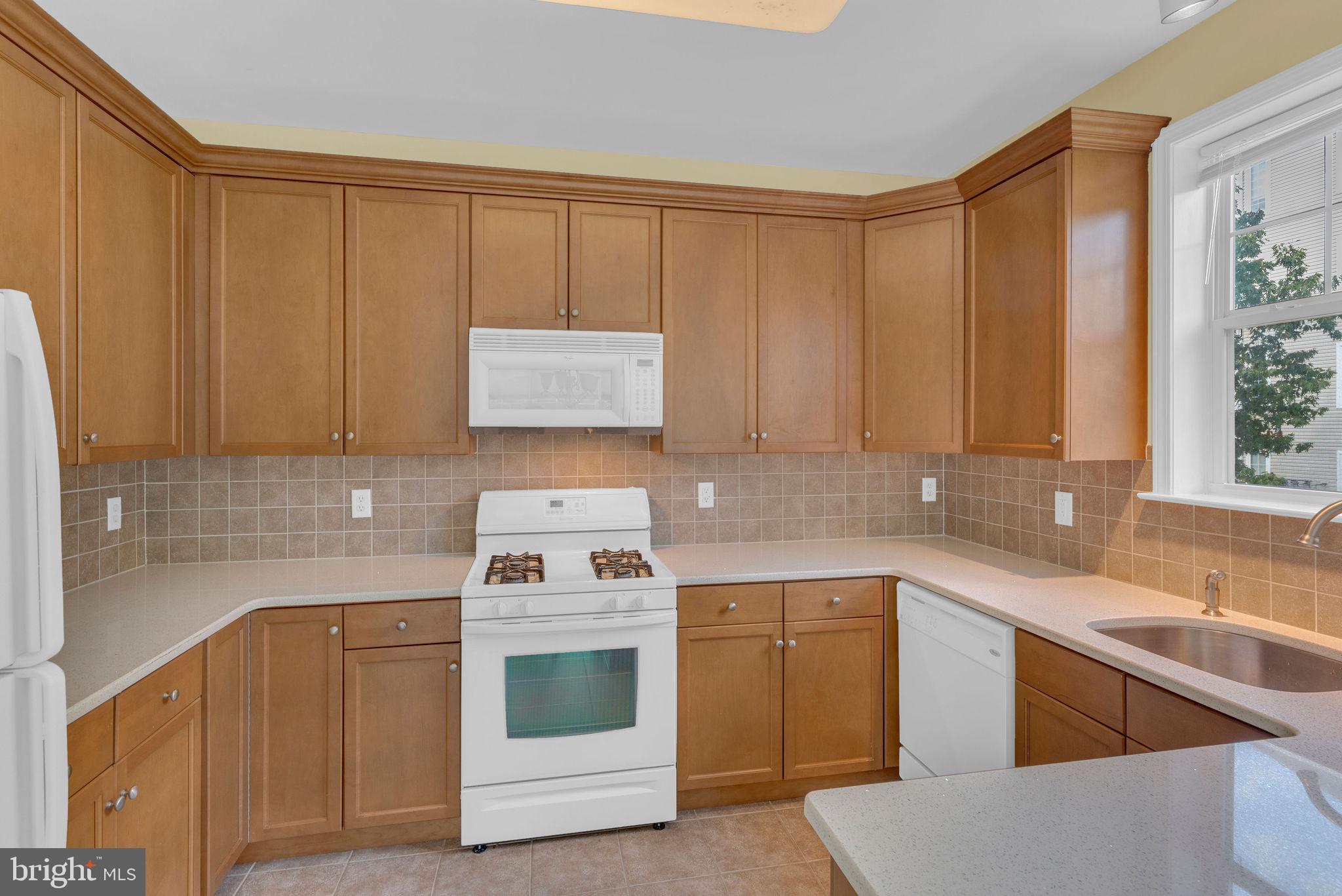 222 Masterson Court Ewing, NJ 08618 - Photo 18 of 43 a kitchen with a sink stove and cabinets