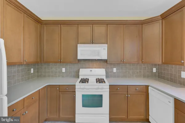 a kitchen view with stainless steel appliances a refrigerator a sink a stove and a window