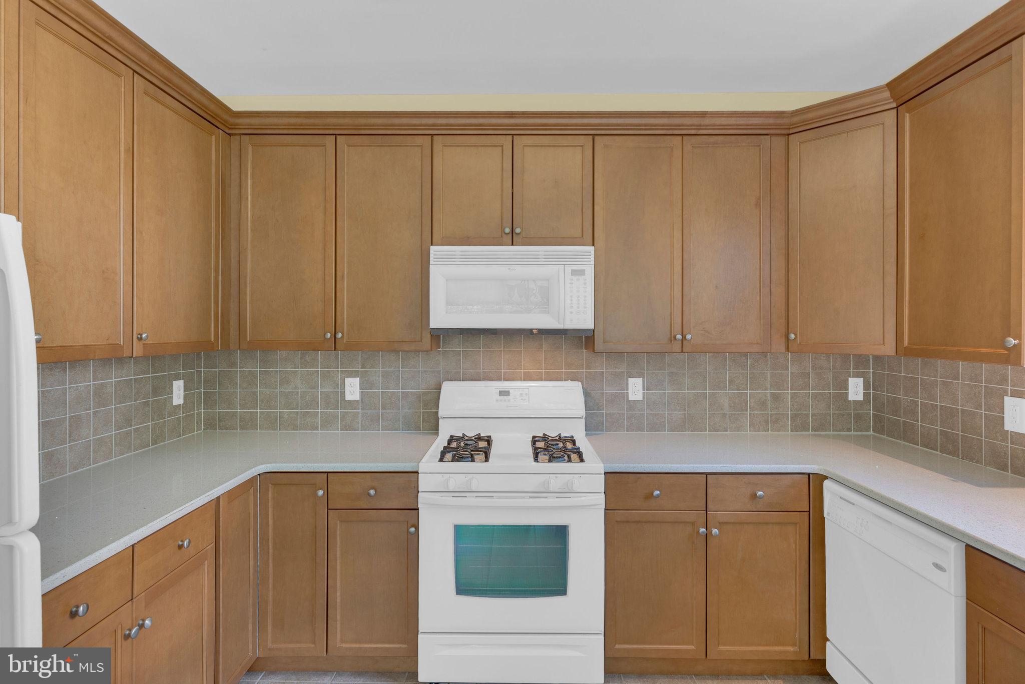 222 Masterson Court Ewing, NJ 08618 - Photo 21 of 43 a kitchen with granite countertop a sink a stove and cabinets