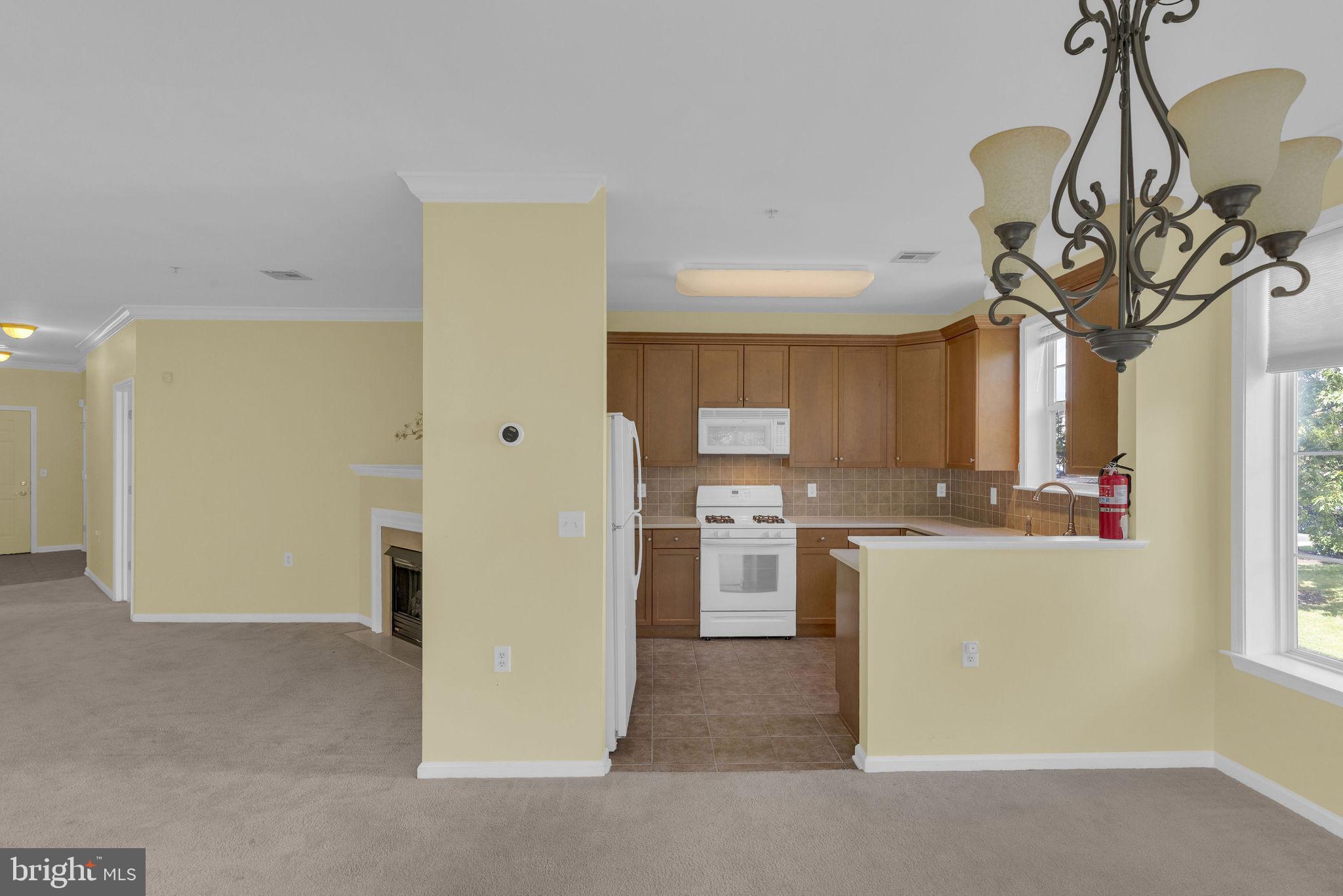 222 Masterson Court Ewing, NJ 08618 - Photo 22 of 43 a kitchen view with stainless steel appliances a refrigerator a sink a stove and a window