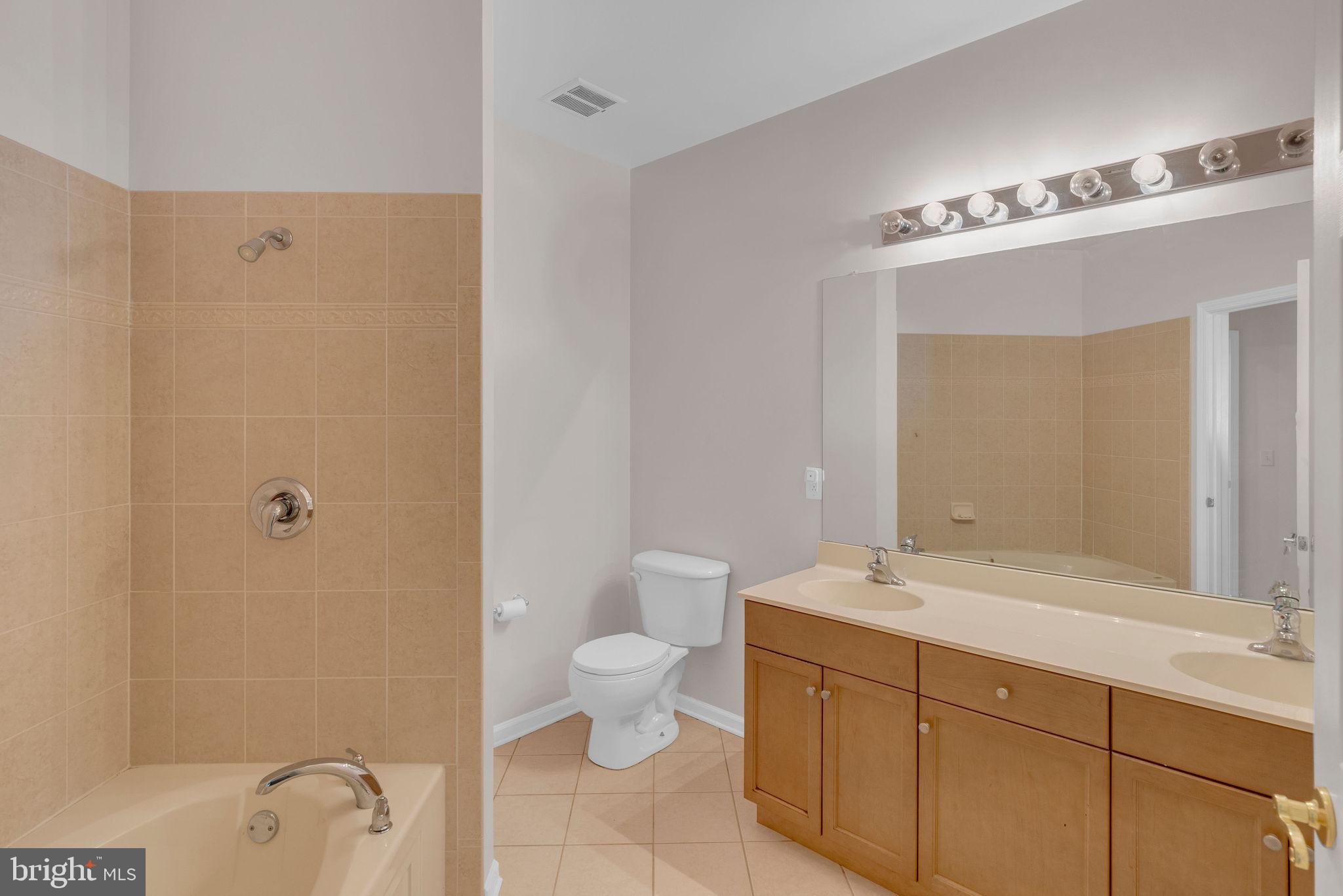 222 Masterson Court Ewing, NJ 08618 - Photo 25 of 43 a bathroom with a double vanity sink a mirror and a toilet