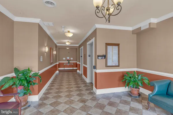 a lobby with furniture and potted plant