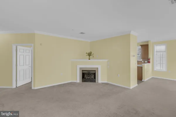a view of an empty room with a fireplace
