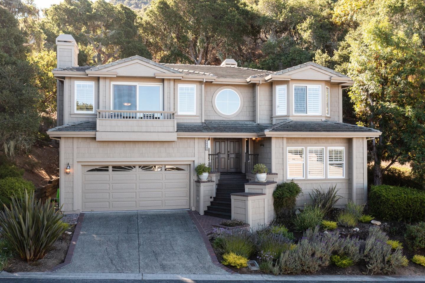 a front view of a house with a yard and garage