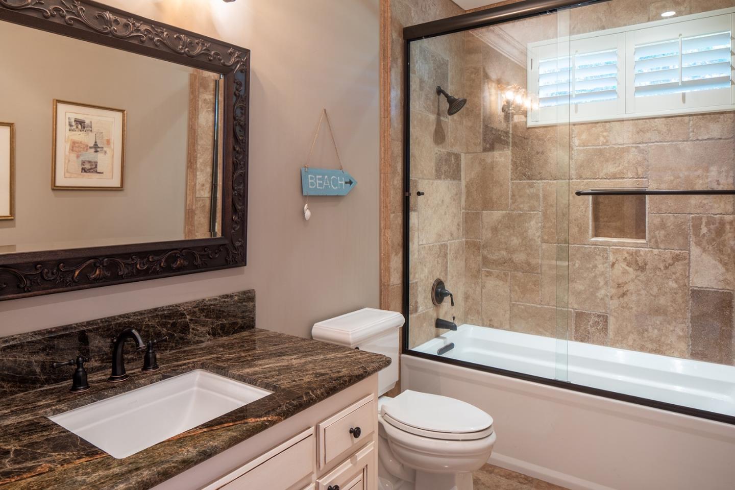 10448 Fairway Lane Carmel, CA 93923 - Photo 14 of 21 a bathroom with a granite countertop sink toilet and shower