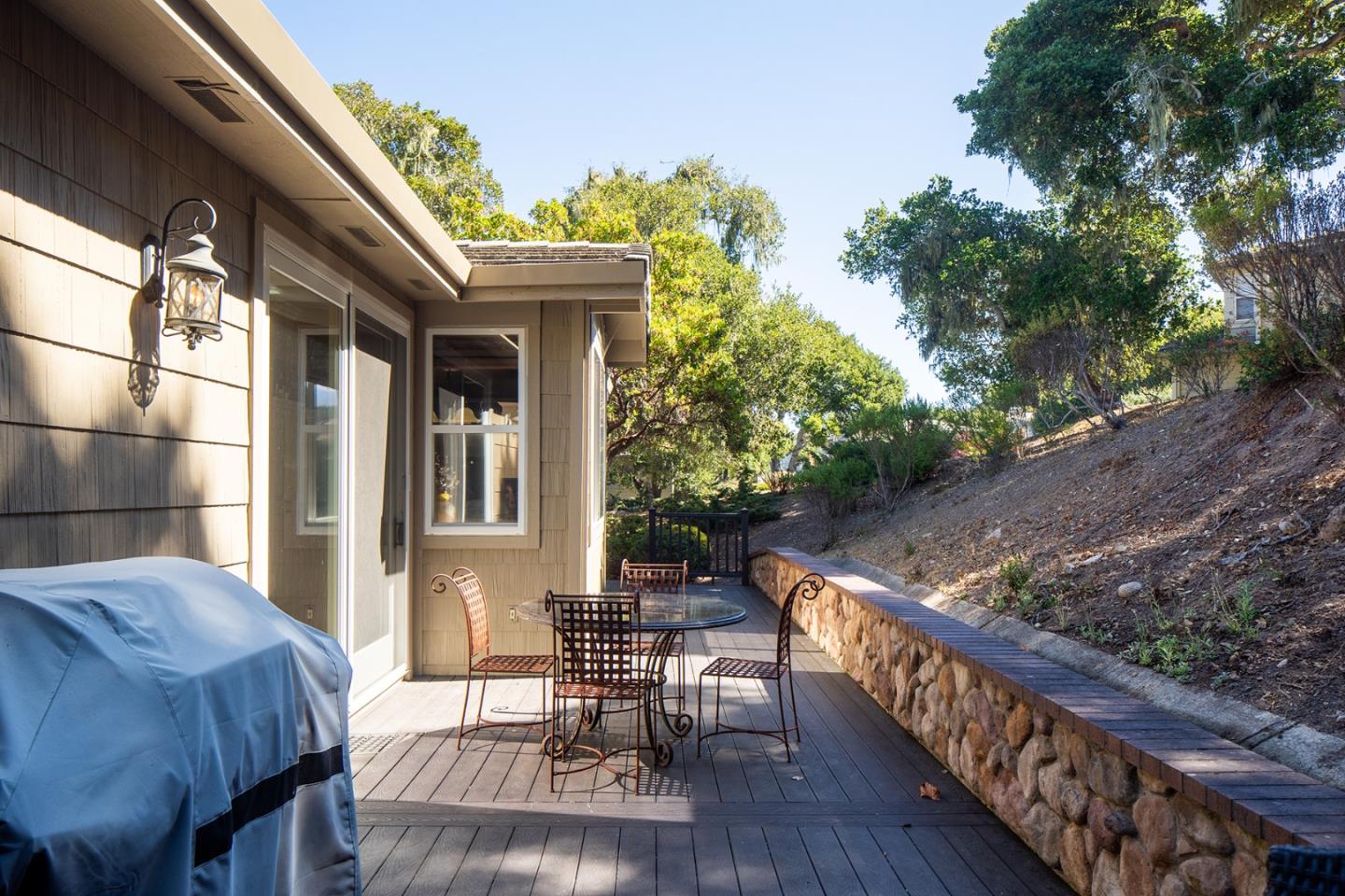 10448 Fairway Lane Carmel, CA 93923 - Photo 18 of 21 a view of a patio with table and chairs with wooden floor and fence