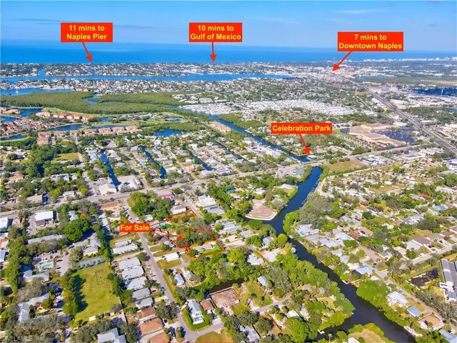 an aerial view of residential houses with outdoor space and swimming pool