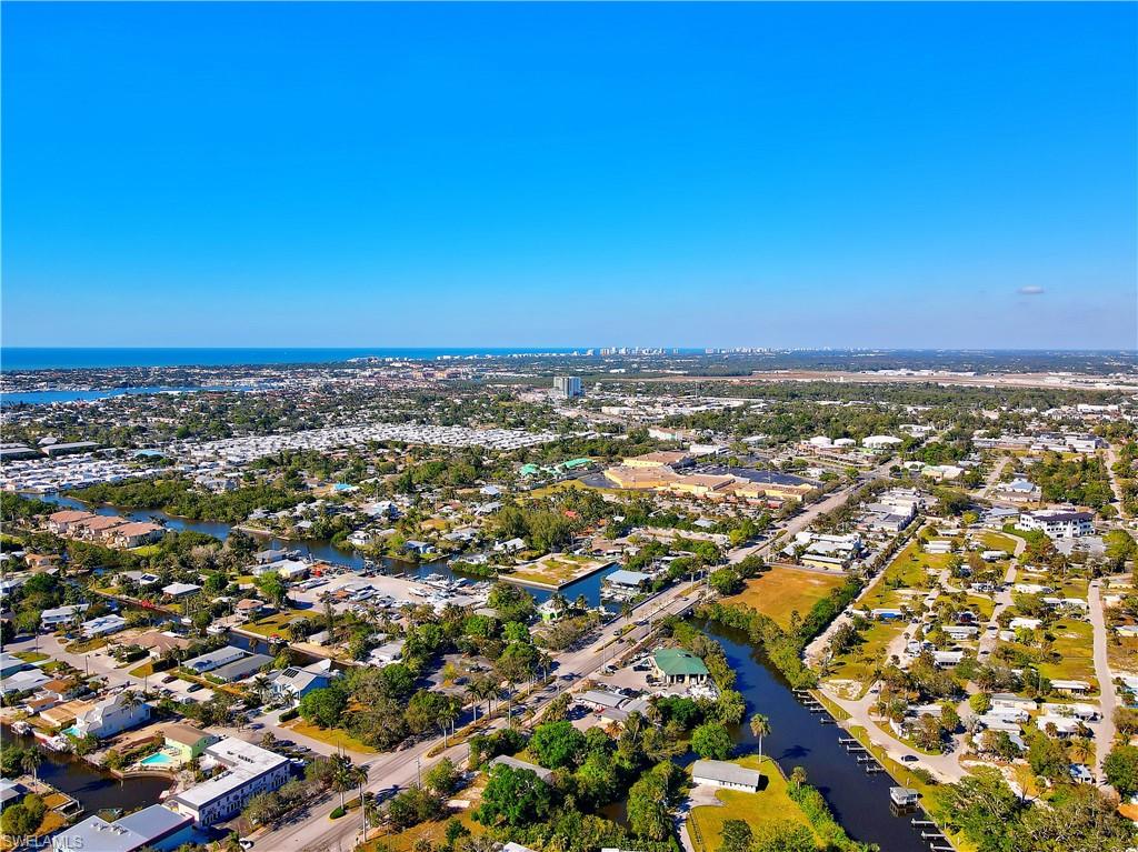 3054 Coco Avenue Naples, FL 34112 - Photo 7 of 13 an aerial view of residential building and trees around