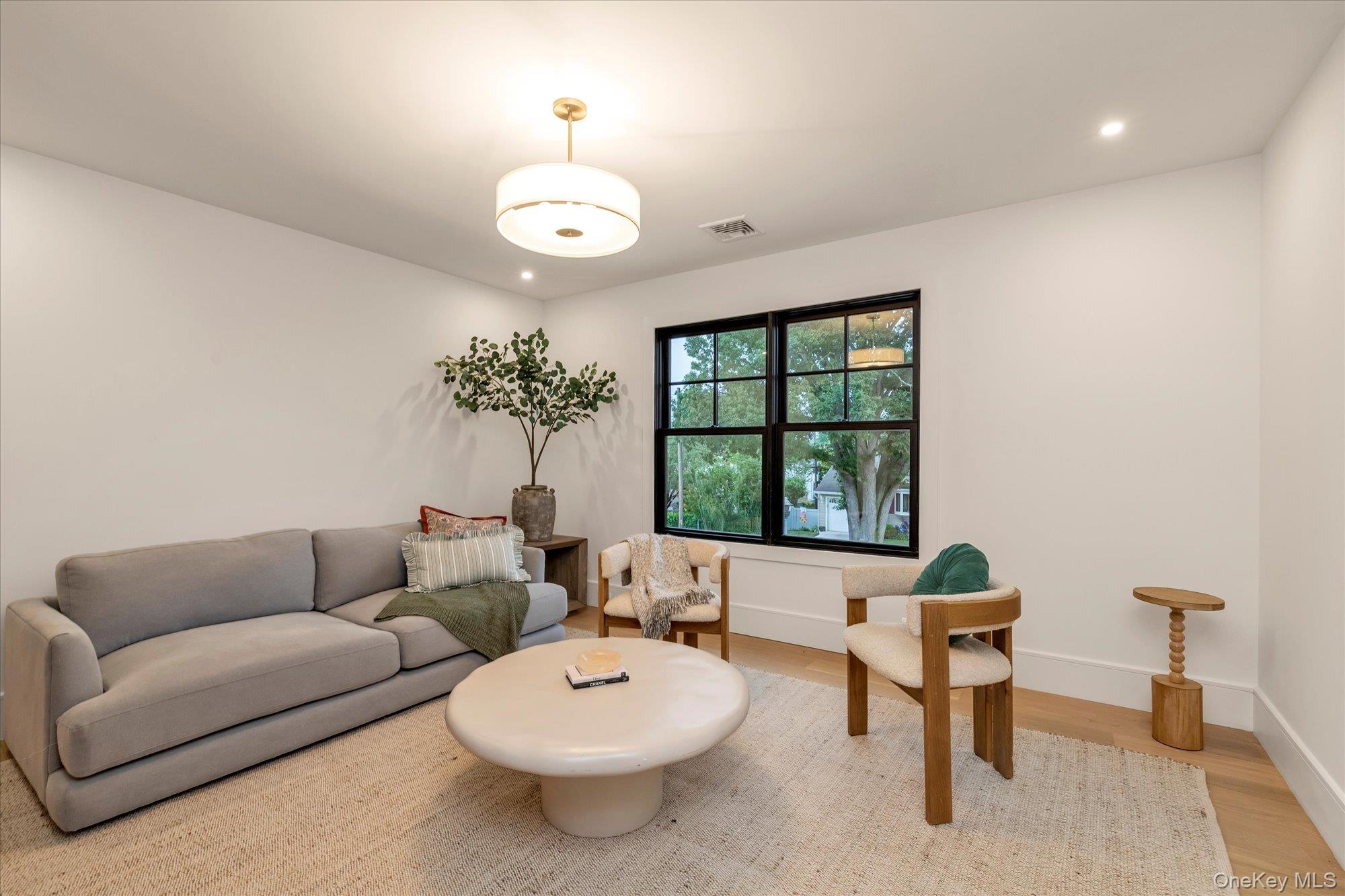 1497 Carroll Street Wantagh, NY 11793 - Photo 14 of 18 Living area featuring recessed lighting and light wood finished floors
