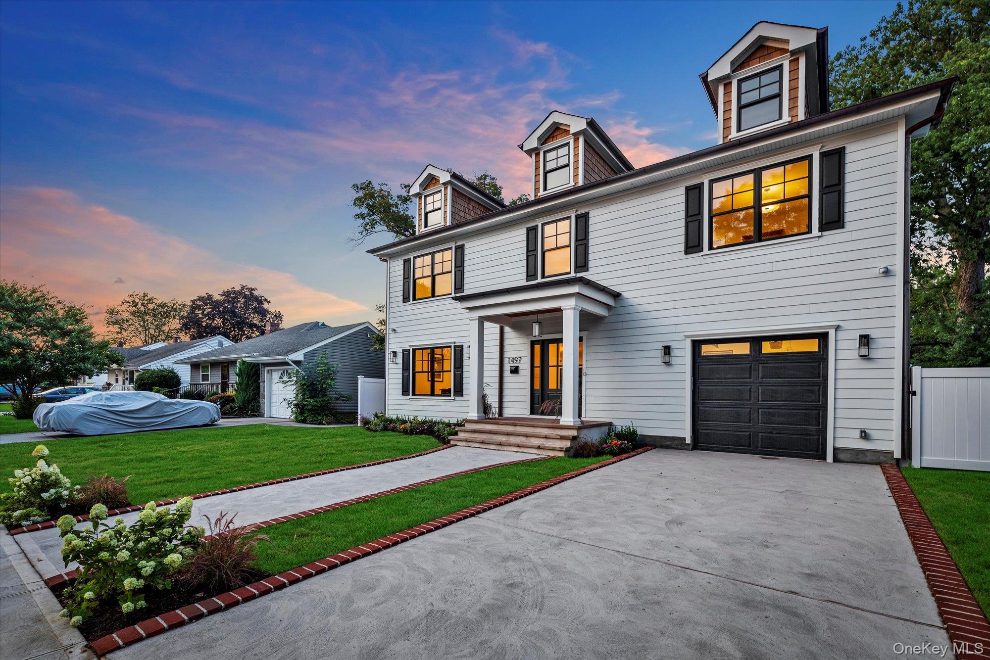 1497 Carroll Street Wantagh, NY 11793 - Photo 18 of 18 View of front of house featuring driveway and a garage