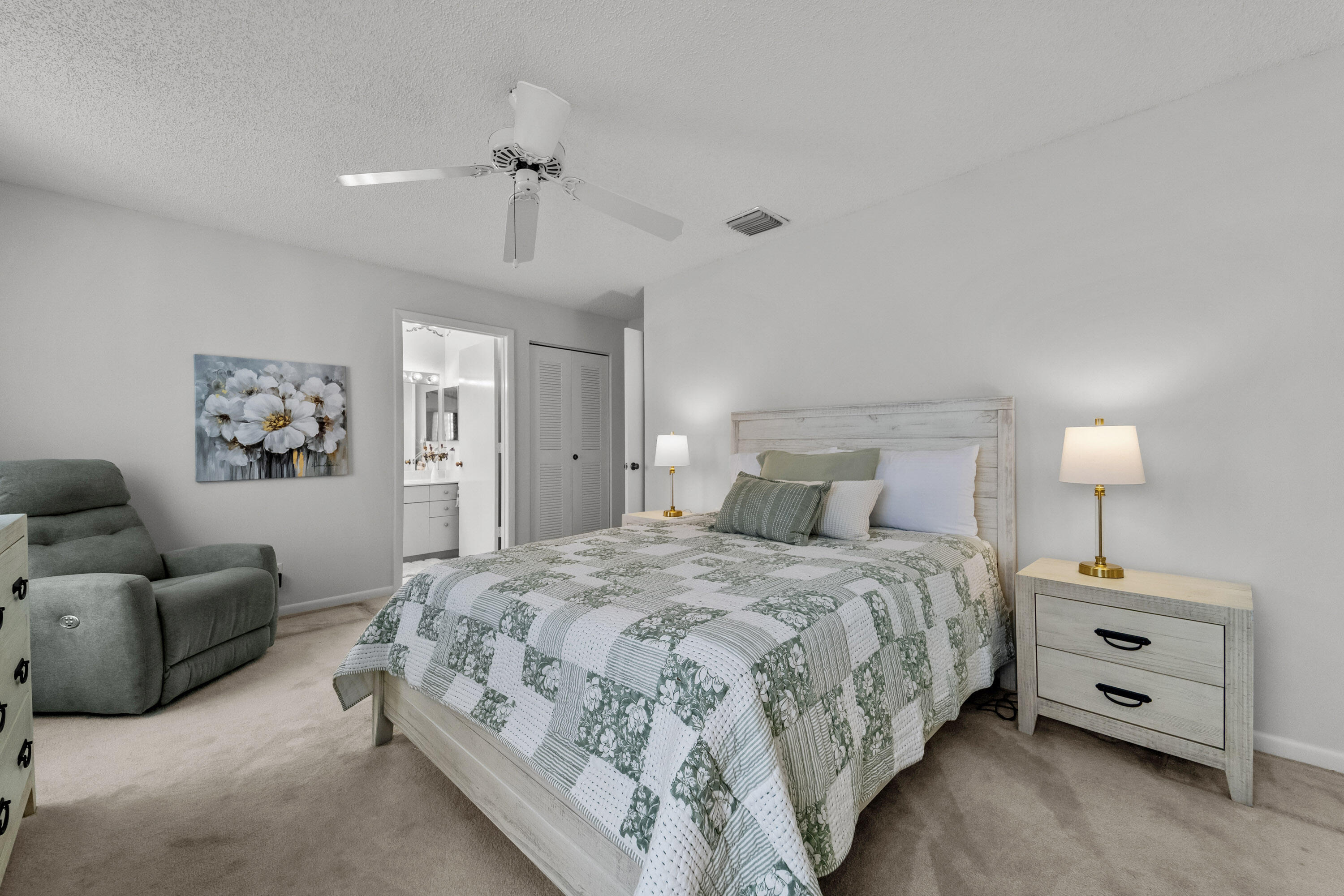 5080 Nesting Way, Unit A Delray Beach, FL 33484 - Photo 11 of 37 a bedroom with a bed and a chandelier