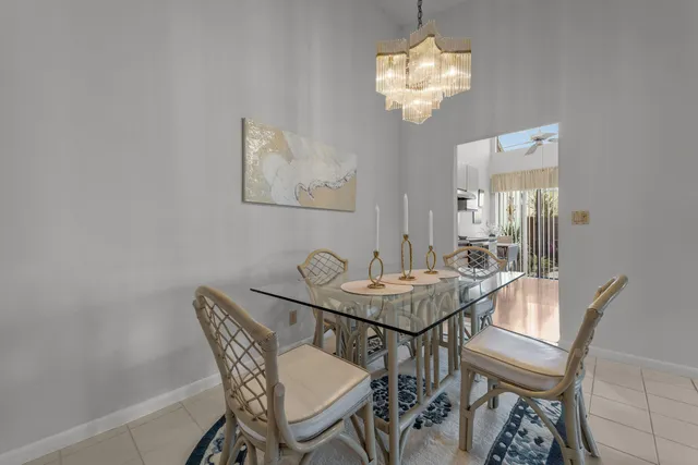 a view of a dining room with furniture and chandelier