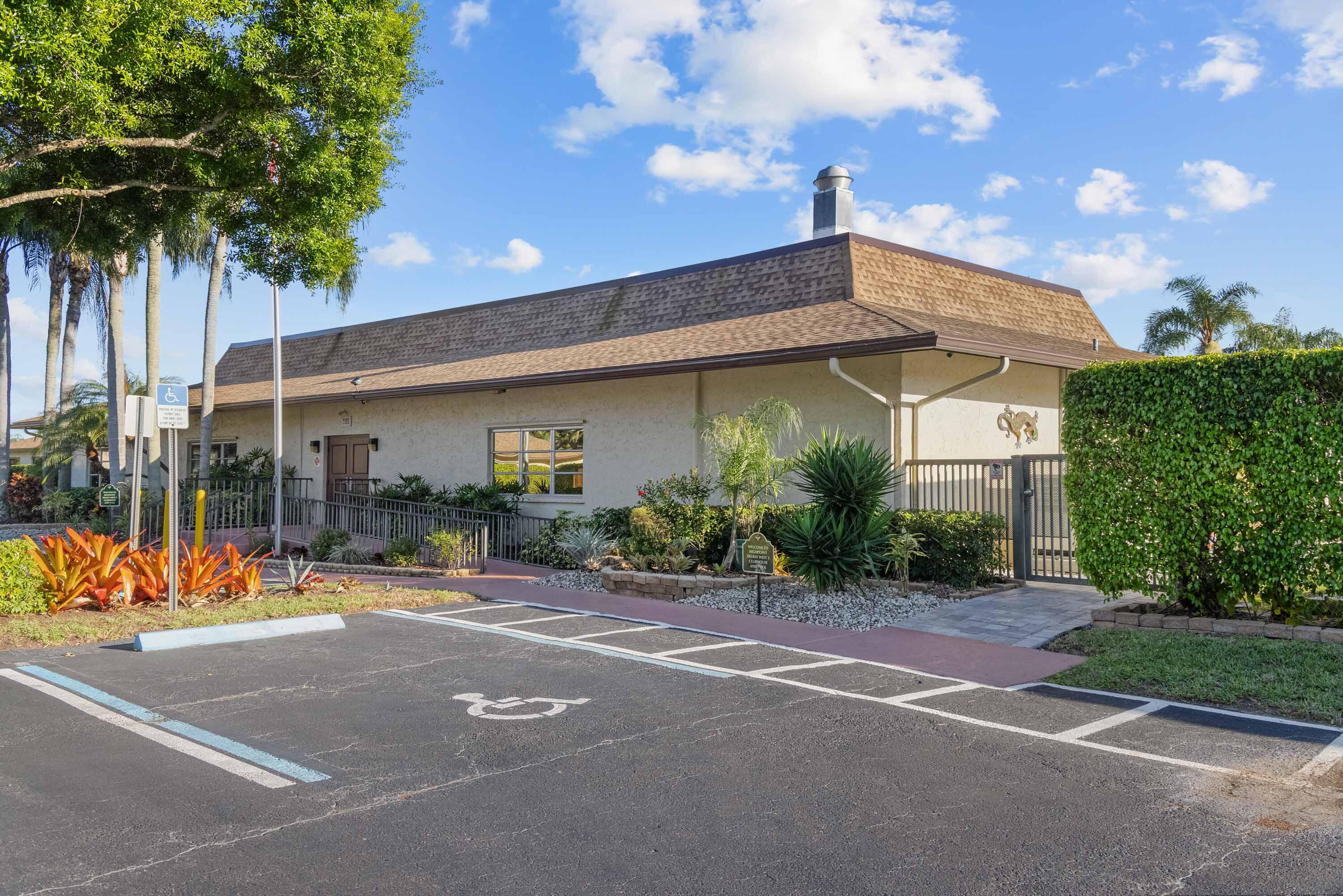 5080 Nesting Way, Unit A Delray Beach, FL 33484 - Photo 35 of 37 a view of a patio with a table and chairs under an umbrella