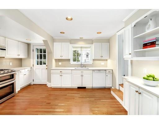 12 Cleveland Road Wellesley, MA 02481 - Photo 11 of 25 a large white kitchen with granite countertop a stove a sink a window and white cabinets