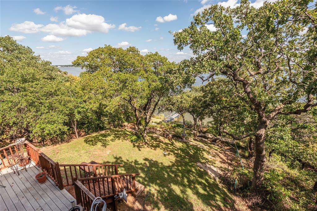 698 Storey Road Nocona, TX 76255 - Photo 11 of 34 Deck featuring a lawn
