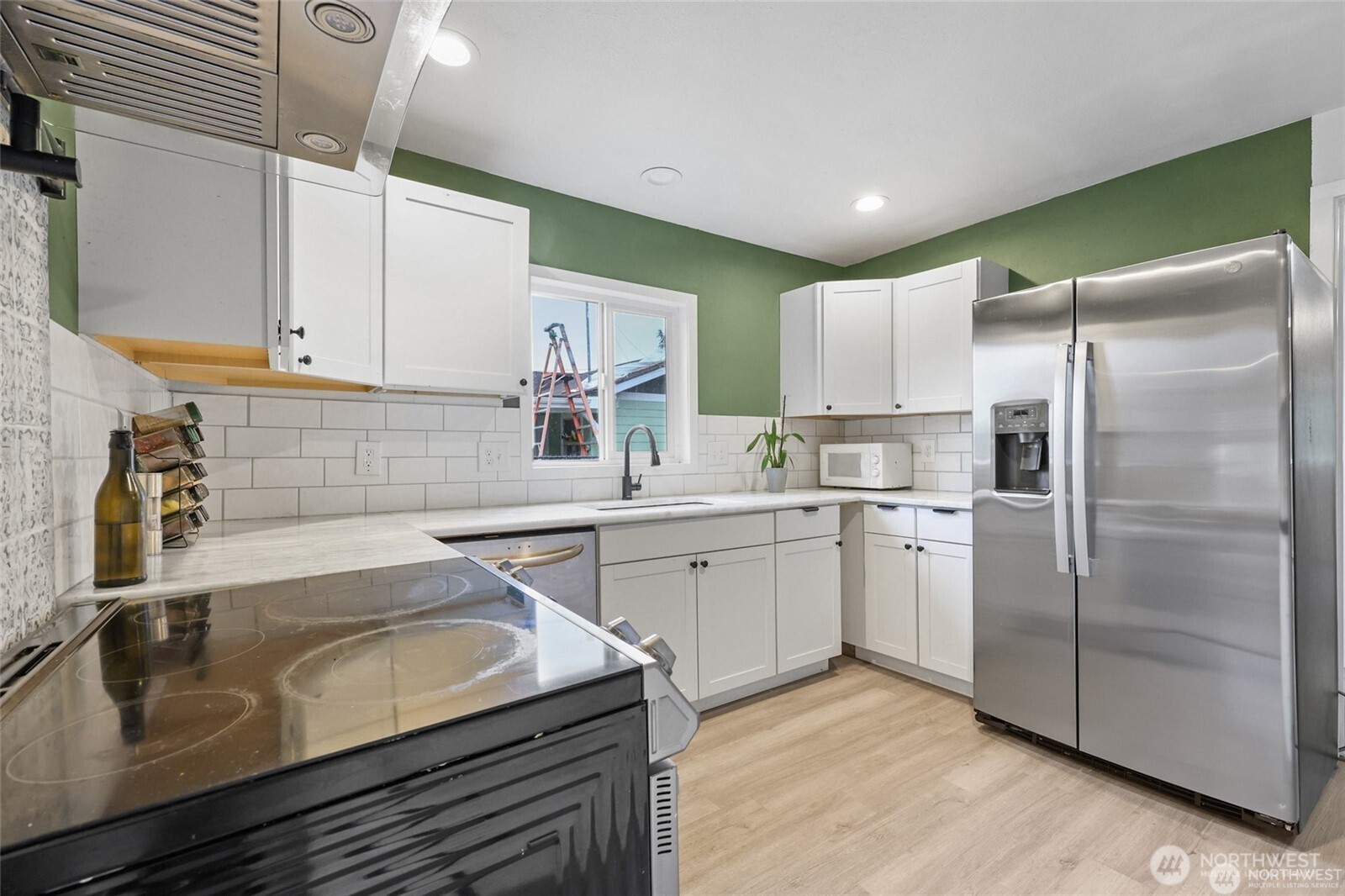 325 East Perry Street Aberdeen, WA 98520 - Photo 12 of 27 a kitchen with a sink a refrigerator and cabinets