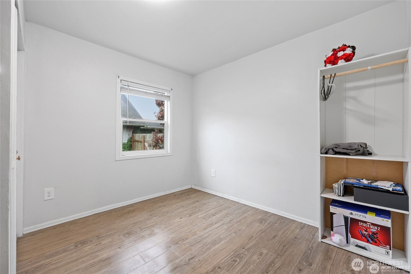 325 East Perry Street Aberdeen, WA 98520 - Photo 22 of 27 a view of an empty room with wooden floor and a window