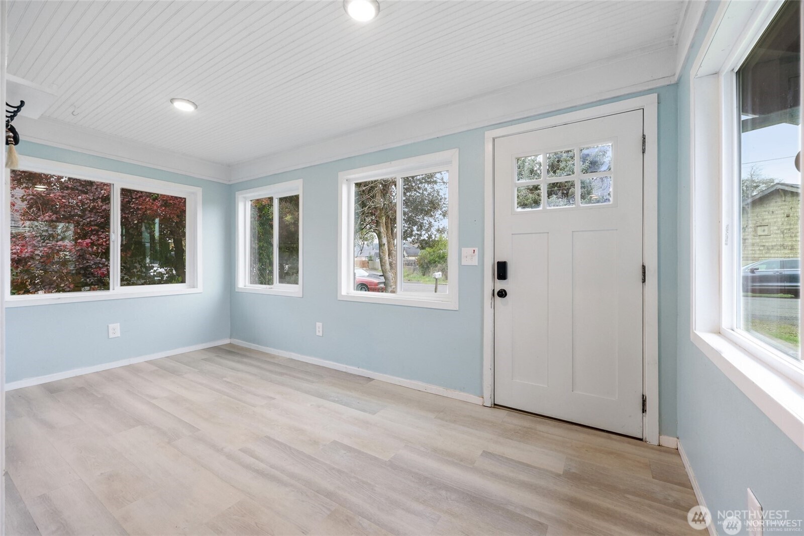 325 East Perry Street Aberdeen, WA 98520 - Photo 6 of 27 a view of an empty room with a window and wooden floor