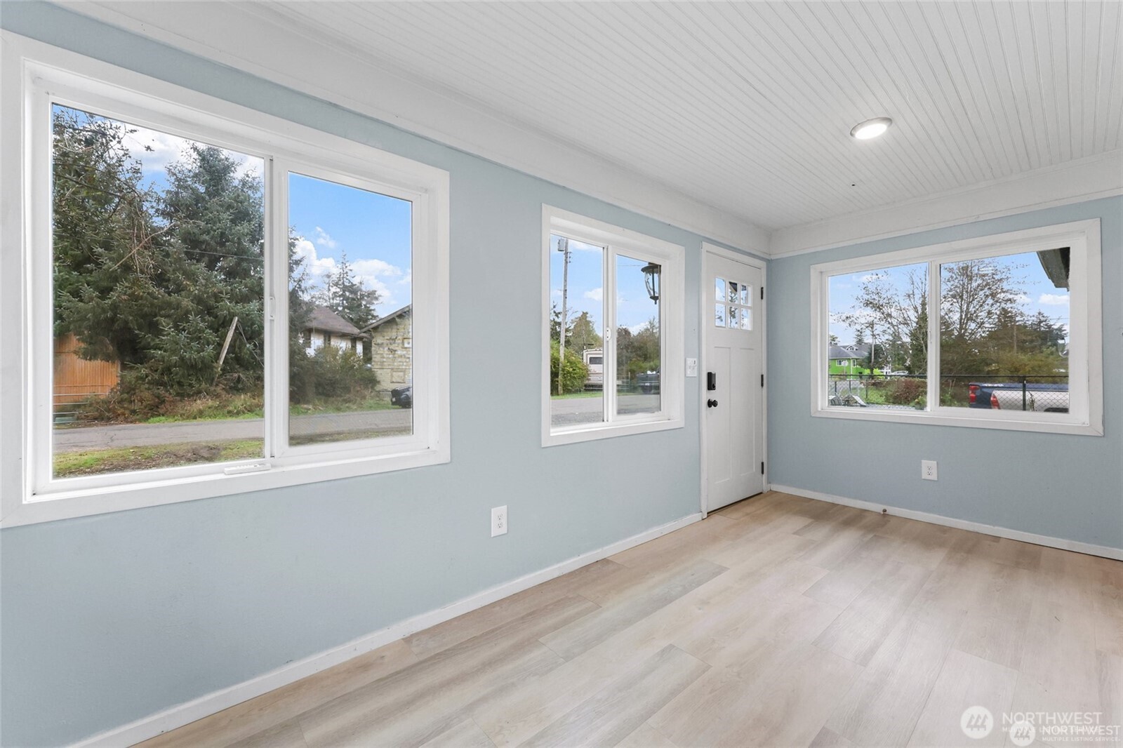 325 East Perry Street Aberdeen, WA 98520 - Photo 7 of 27 a view of an empty room with a window and wooden floor