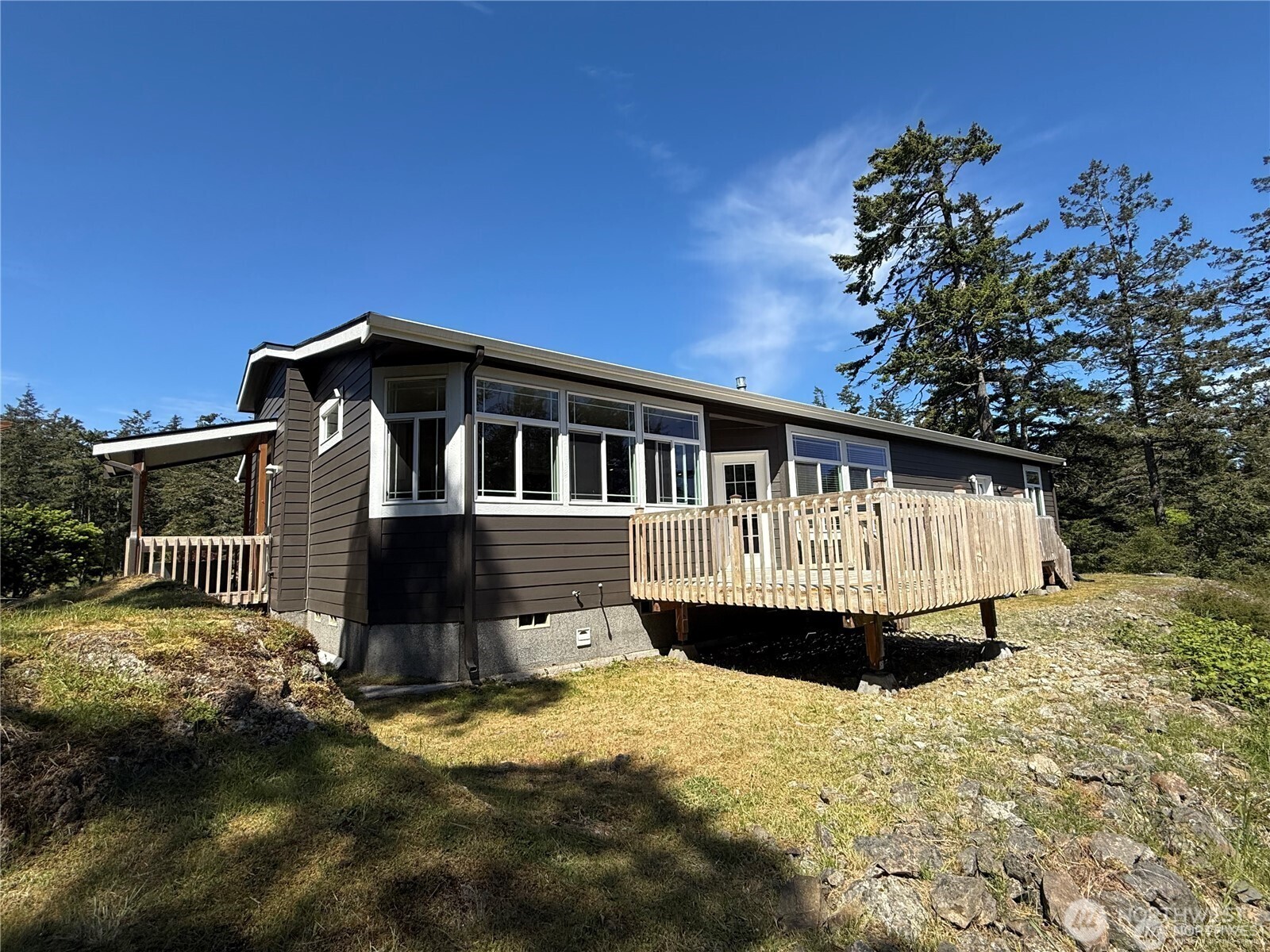 168 Jackson Road Orcas Island, WA 98245 - Photo 12 of 40 a front view of a house with a yard covered with snow