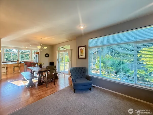 a view of a dining room with furniture a chandelier and wooden floor